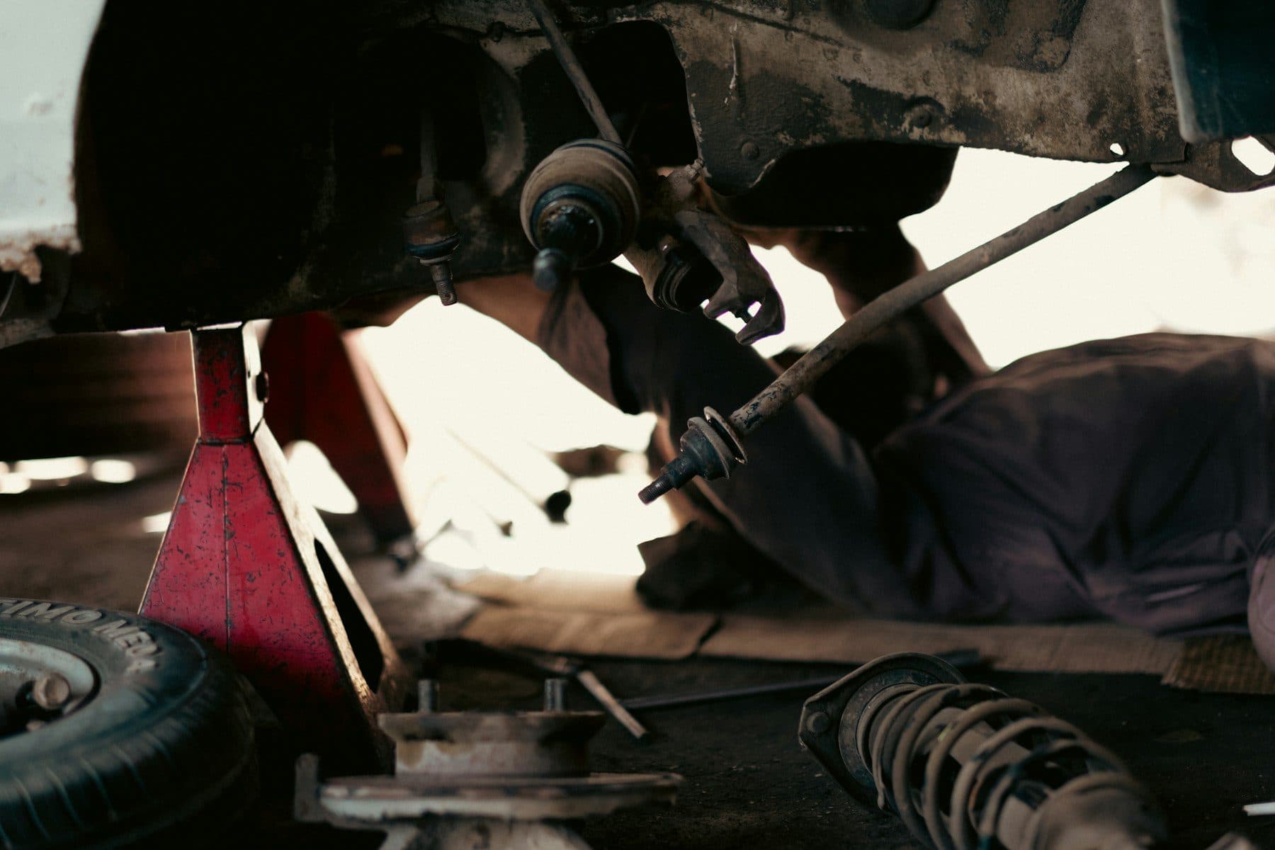 Mechanic working under a lifted car