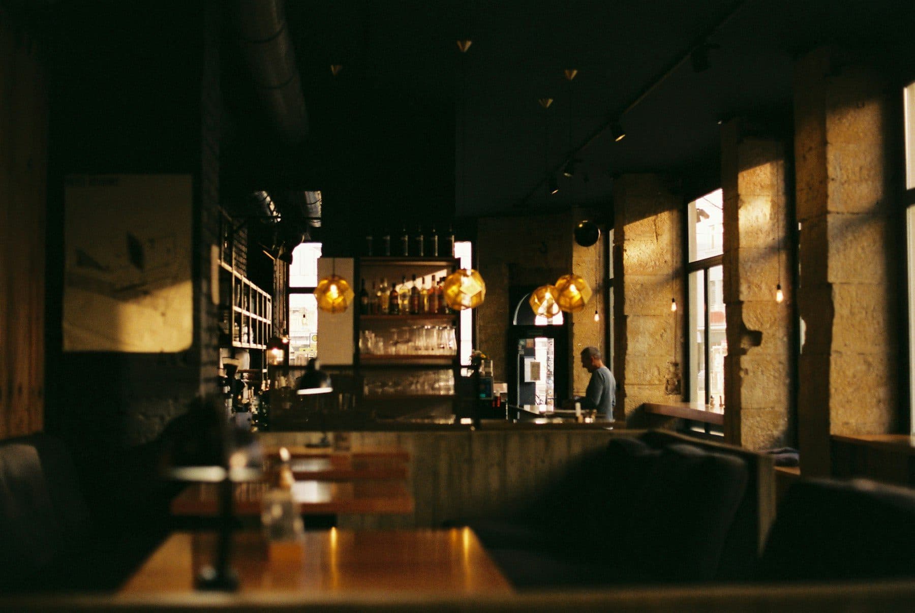 Warmly lit restaurant interior with wooden tables